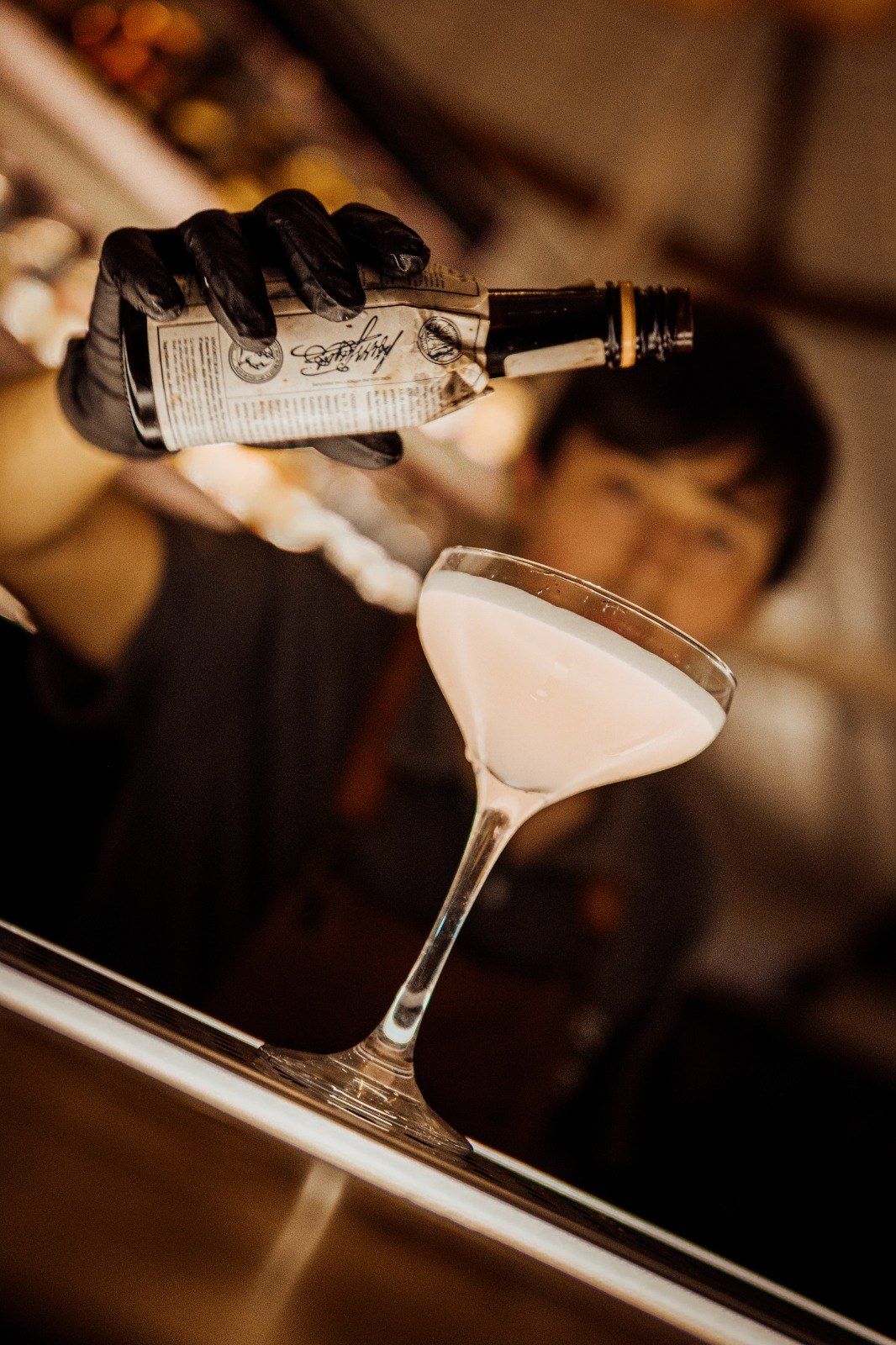 El bartender terminando un cóctel en la barra del salón